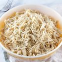 A vintage yellow bowl full of shredded chicken