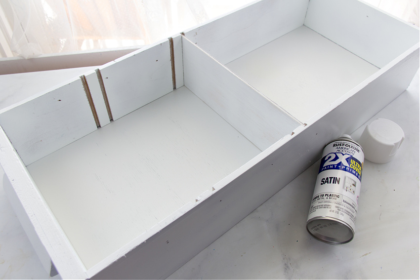 a drawer painted white and turned into a wall mounted shelf