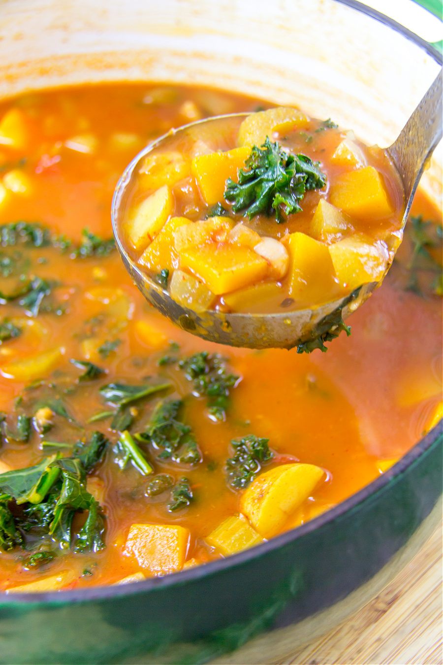 autumn vegetable soup in a pot with a ladle