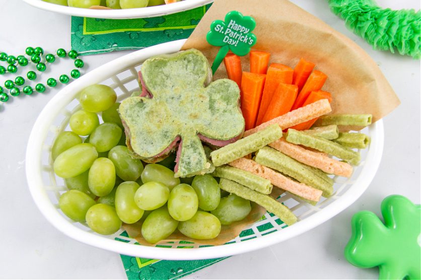 a st patricks day food tray with shamrock quesadillas, vegetable straws, carrot sticks, and green grapes