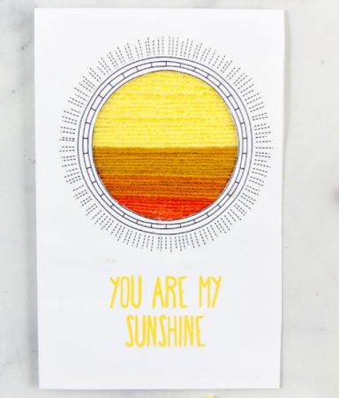 a homemade greeting card with a yarn scraps sun with the words you are my sunshine