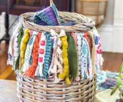 diy boho basket with a fringe made out of fabric, yarn, and ribbon
