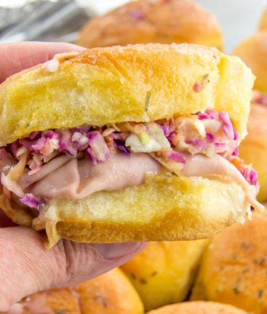 baked turkey and cheese sliders topped with mango coleslaw