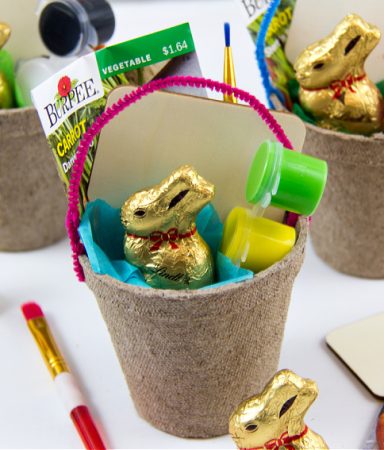 an easter basket made out of a seed starter tub and filled with carrot seeds, a plant marker, and paint