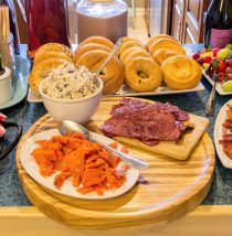 bagel bar with salmon, bacon, chicken salad, and other toppings