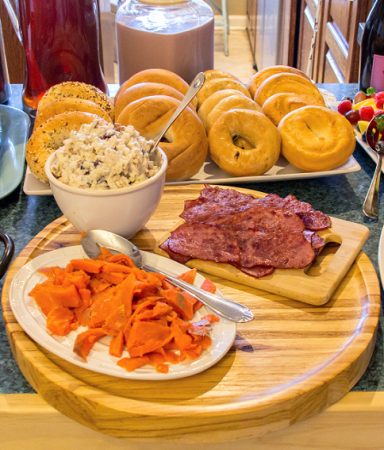 bagel bar with salmon, bacon, chicken salad, and other toppings