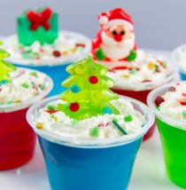 christmas jello treats for kids with whipped topping and gummy christmas candy on top