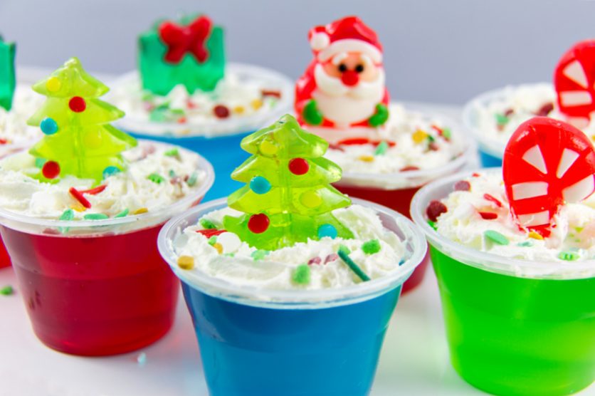 christmas jello treats for kids with whipped topping and gummy christmas candy on top