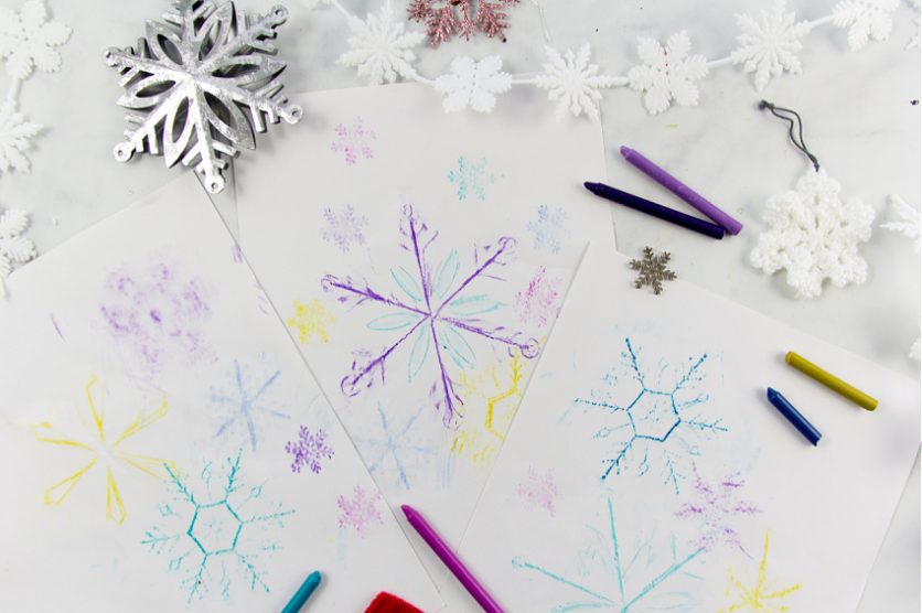 snowflake art rubbings using crayons and Christmas snowflake ornaments