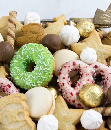 dessert tray for a christmas party with shortbread, meringue, wafers, chocolate, macarons