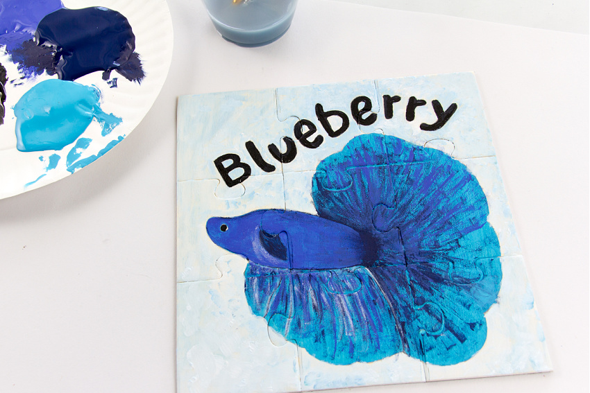 a blue betta fish painted using acrylic paints onto a wood puzzle