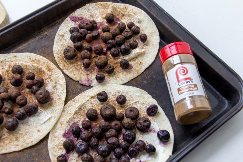 tortillas topped with blueberries, cream cheese, and cinnamon.