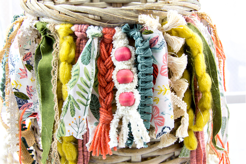 boho fringe made out of ribbon, yarn, and fabric added to a basket