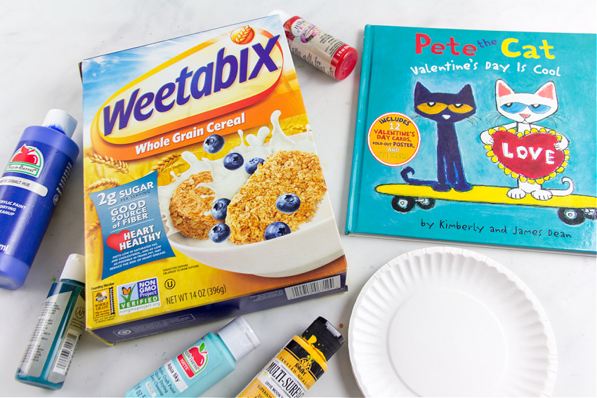 a cereal box, paint, and paper plate with the book Pete the Cat Valentine's Day is Cool