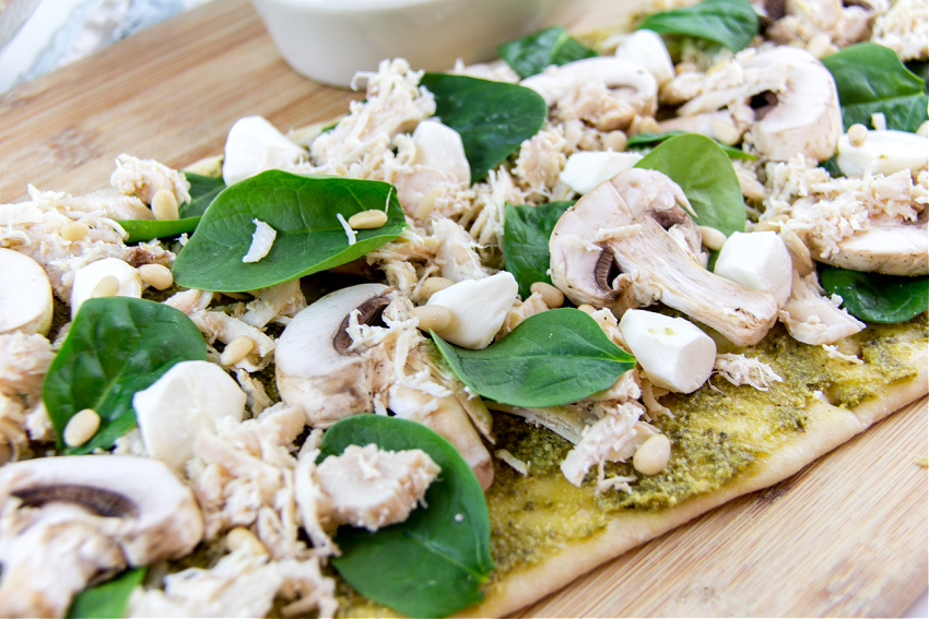 chicken, spinach, mushrooms, mozzarella, and pesto on flatbread