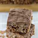 chocolate rice krispies squares with a layer of melted chocolate on top