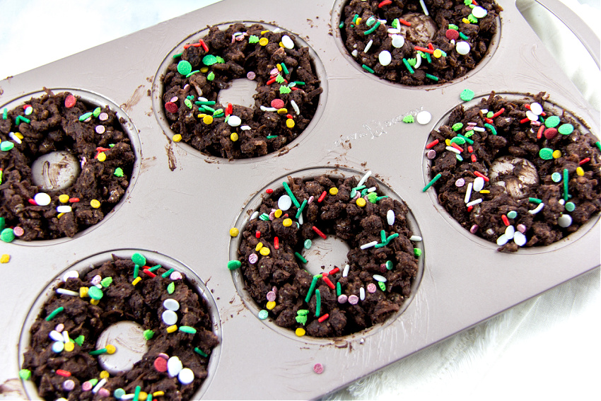 chocolate crackle wreaths for christmas made in a donut pan.