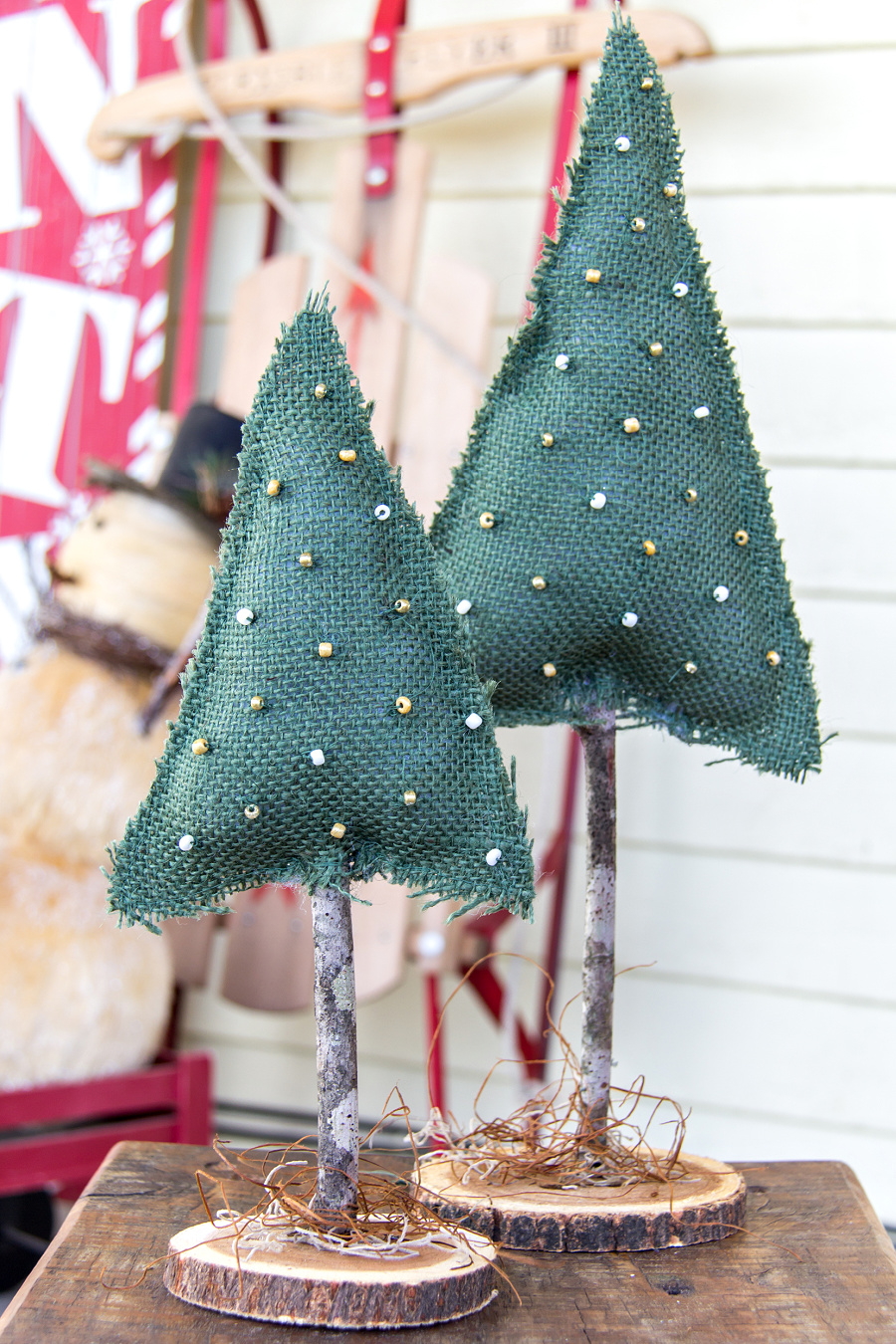 christmas trees made out of burlap, a wood slice, and a stick