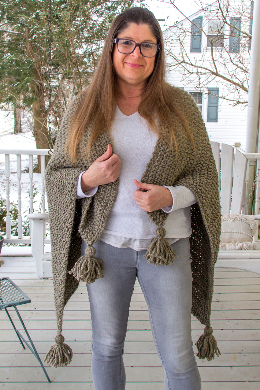 a handmade olive green chunky knit shawl with tassels