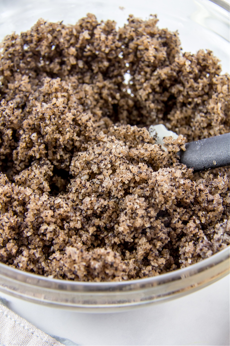 diy coffee salt scrub being mixed in a bowl