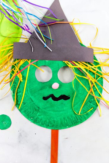 Make a Bright and Colorful Paper Plate Witch Mask - Make and Takes