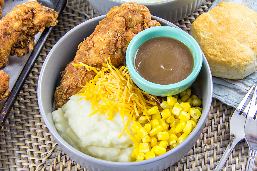 copycat KFC Famous Bowl with fried chicken, mashed potatoes, corn, and gravy