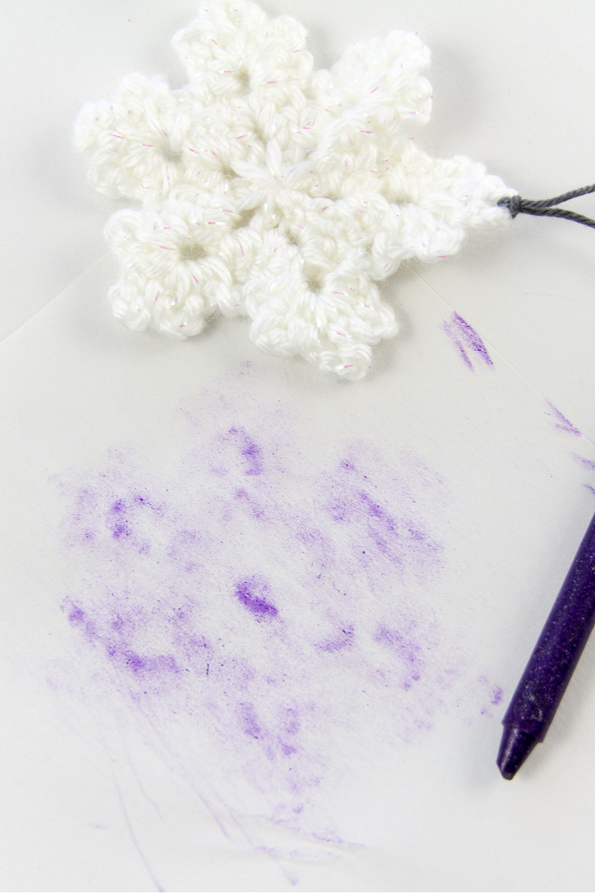 crayon rubbing over a crochet snowflake