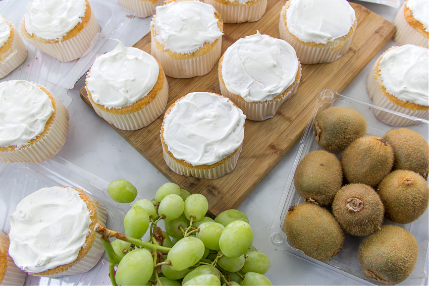 whipped topping spread on mini angel food cakes