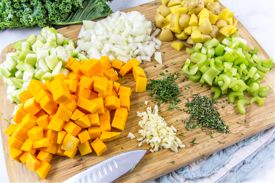 squash, potatoes, celery, onion, fresh herbs, and garlic cubed and diced for harvest soup