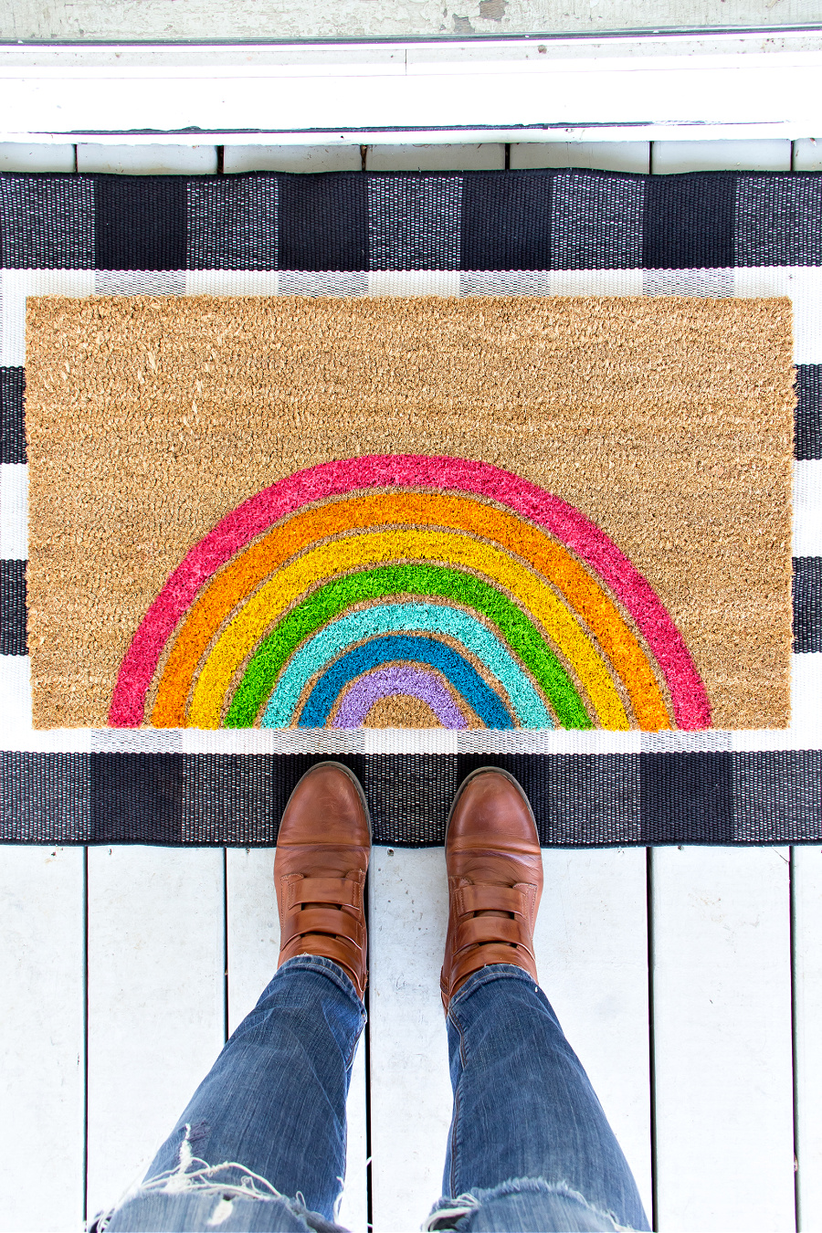 a hand painted rainbow doormat