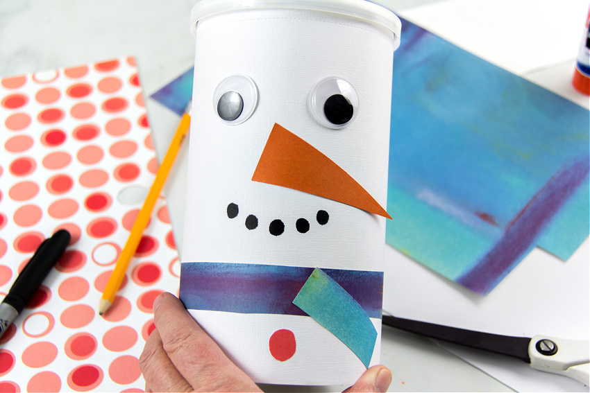 oatmeal container turned into a snowman snack container using scrapbook paper and googly eyes