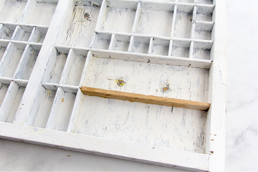 vintage typeset tray with extra wood added to larger compartments