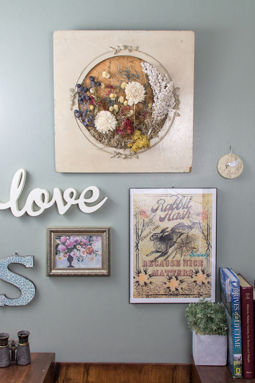 dried flower wall art in a frame on a gallery wall