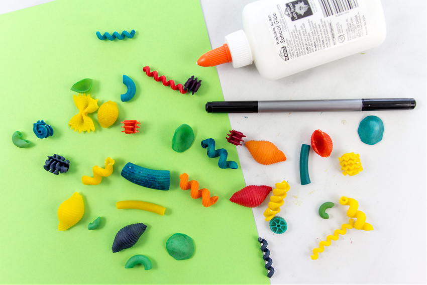 colorful pasta and a marker to make fun bug crafts with kids