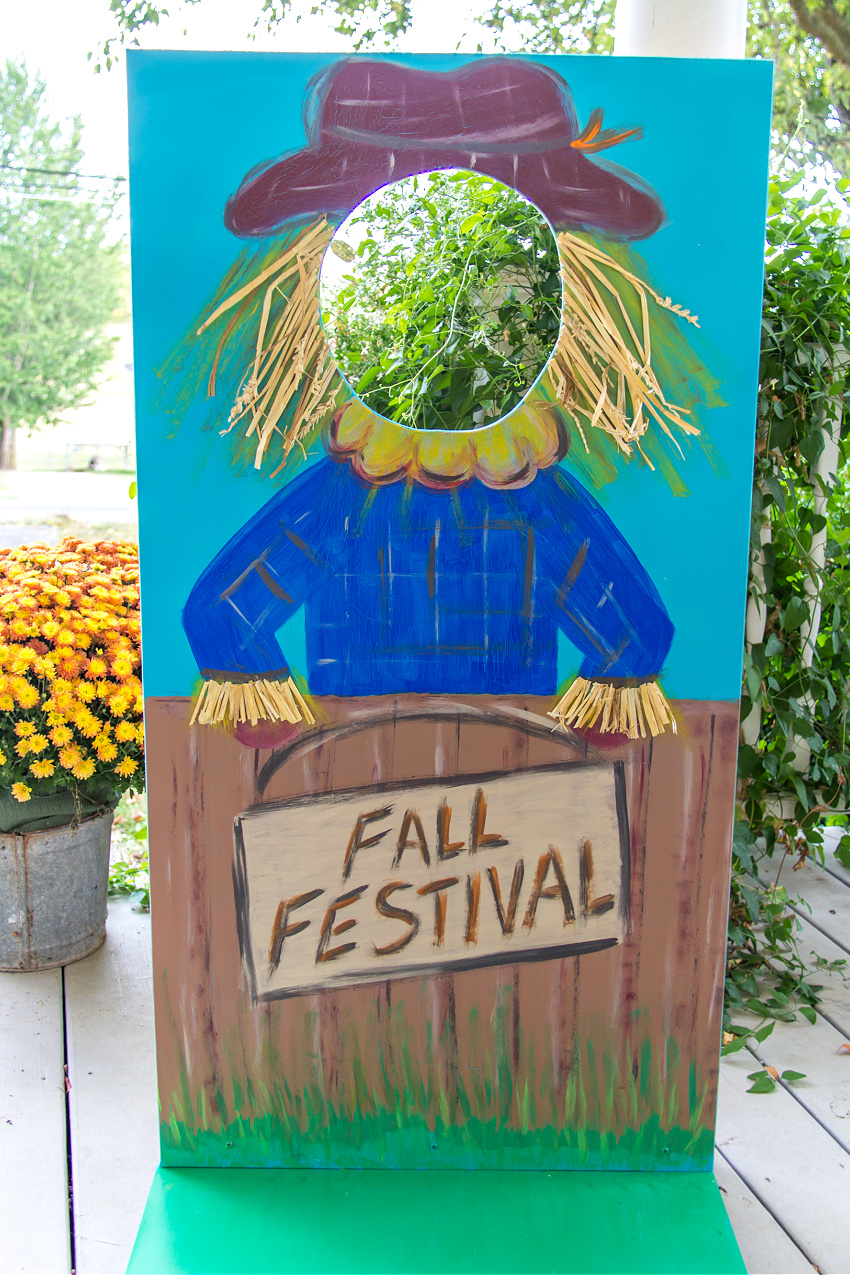a scarecrow photo booth board for a fall festival