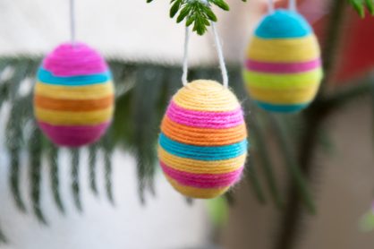 Brighten up your home this Easter with some adorable Hanging Yarn Wrapped Plastic Eggs. It's the perfect holiday craft to make with your kids!