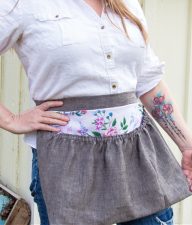 a lady wearing a handmade harvest gathering waist apron