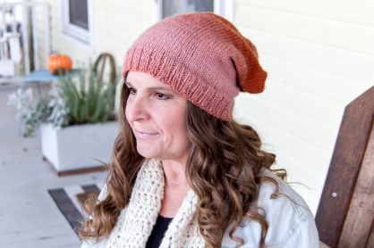 a rust and pink slouch beanie that's been knitting using straight needles
