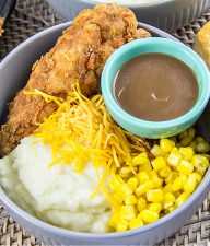 copycat KFC Famous Bowl with fried chicken, mashed potatoes, corn, and gravy