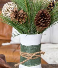 christmas tree branches, pinecones and branch balls in a winter painted vase