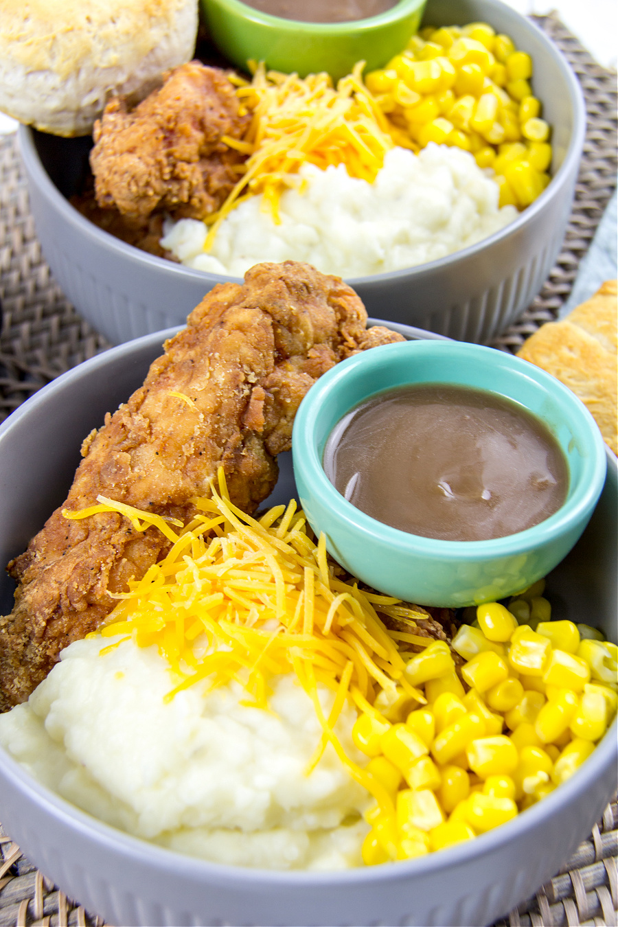 fried chicken strips, mashed potatoes, corn, and gravy in a bowl