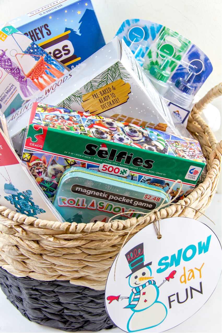 A basket full of activities for snow days including a jigsaw puzzles, games, and crafts