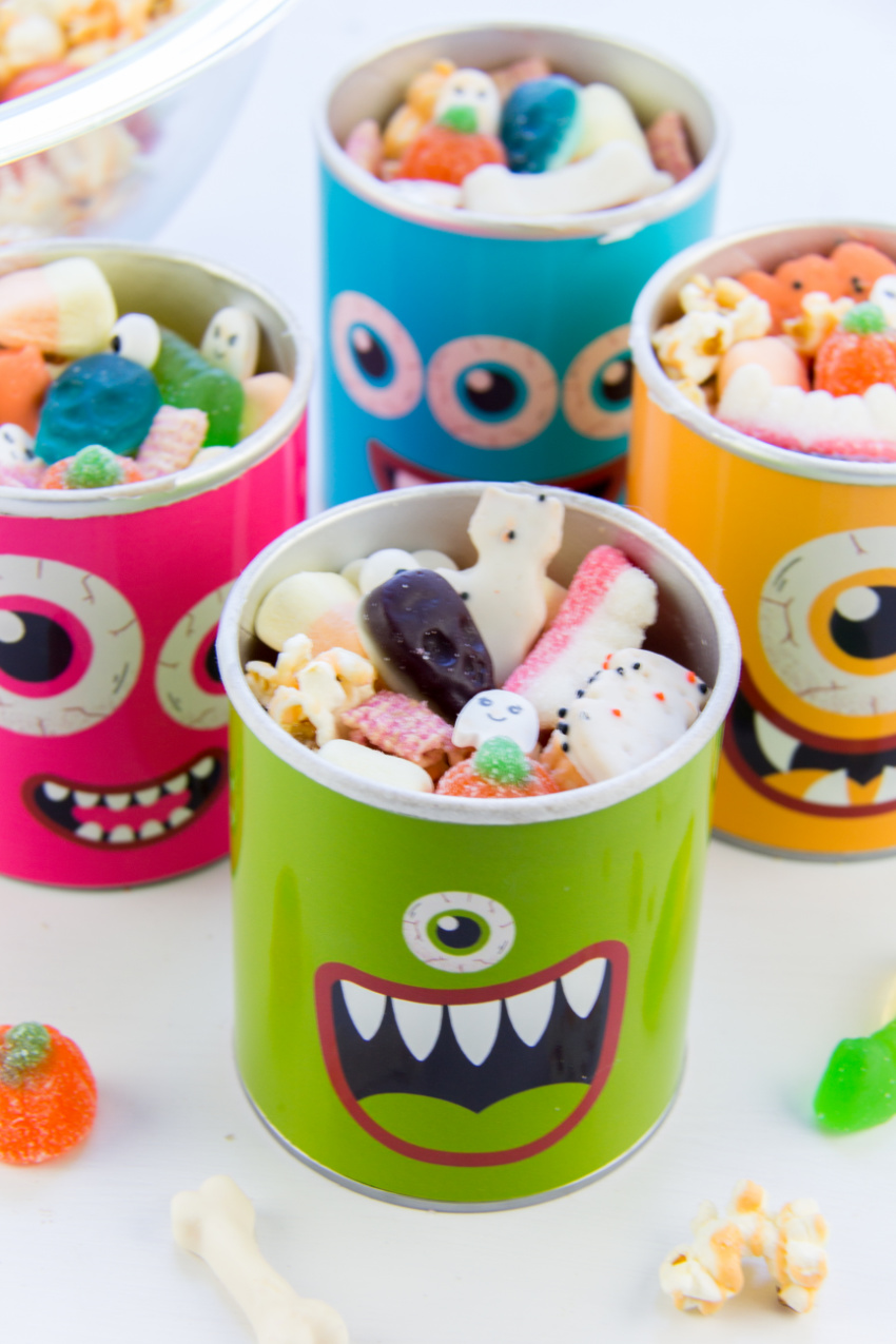Halloween snack mix in small pringles cans wrapped with monster wrappers