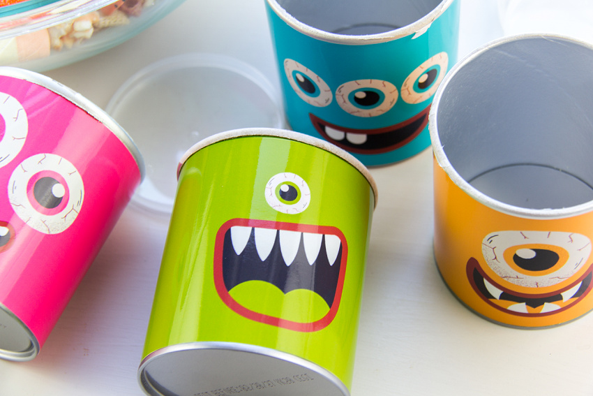 bright and colorful monster wrappers attached to The Good Company 1.6oz potato chip cans
