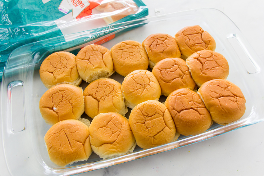 Hawaiian slider buns in a casserole dish for baking sliders