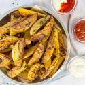 homemade seasoned potato wedges with condiments