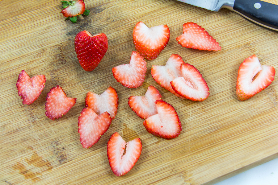 a strawberry cut into a heart shape for a valentines day salad