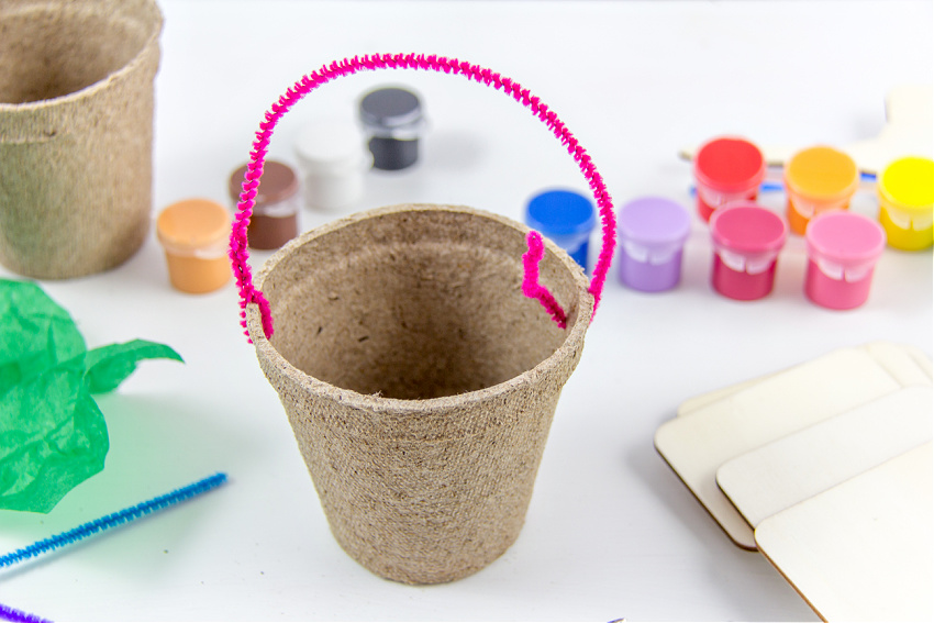 a pipe cleaner handle on a seed starter pot