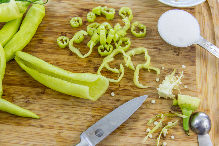 to remove seeds from a banana pepper, slice through one side, and then scoop seeds out