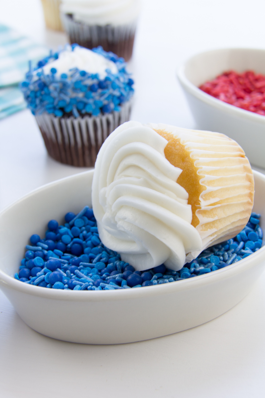 the edges of cupcakes being rolled in sprinkles